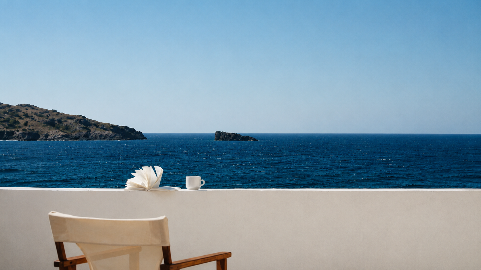 Mediterranean sea view from a white terrace with a wooden chair, book and coffee cup