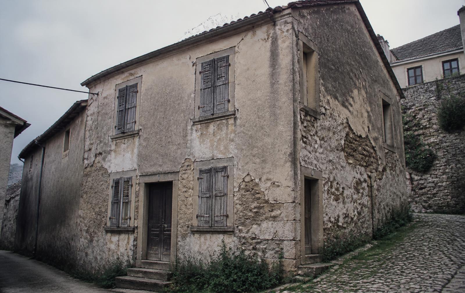 Semi-abandoned stone house in an Italian hill village